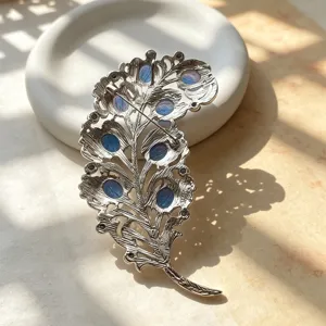 Vintage court style feather brooch with blue stones, elegant metal pin for autumn and winter coats.
