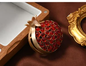 Vintage matte gold pomegranate brooch with red stones, elegant women suit accessory gift.