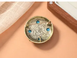 Detailed view of the back of a vintage Chinese style turquoise brooch with secure pin.