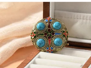 Detailed view of vintage Chinese style retro turquoise brooch with colorful enamel floral accents.