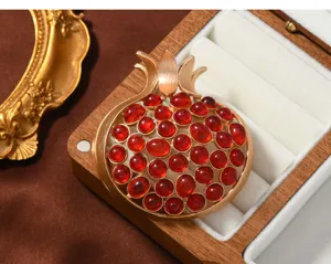 Retro matte gold pomegranate brooch detail shot, elegant fruit pin accessory for women suits.