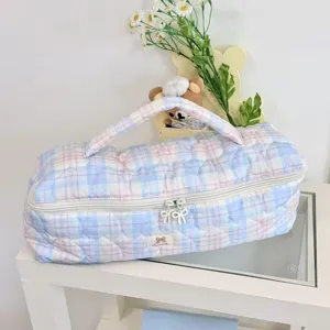 Dettaglio borsa portaoggetti trapuntata a quadri per strumenti per capelli.