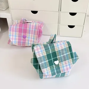 Detailed view of cute plaid mini cosmetic pouch, portable flap coin purse for travel daily use.