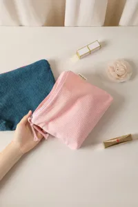 Vintage solid color corduroy makeup bag with zipper tassel, portable travel cosmetic storage pouch details.