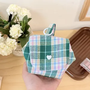 Green plaid quilted storage bag with cute heart button and portable top ring for travel.