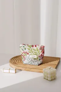 Close-up detail of floral fabric cosmetic bag with exquisite embroidery and zipper.