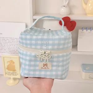 Blue plaid cosmetic bag with cute bow zipper and portable handle for daily storage.