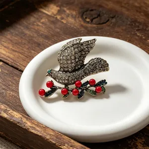 Vintage rhinestone dove brooch for women, elegant crystal bird lapel pin for coats and cardigans.