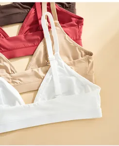 Closeup of adjustable straps and soft triangle cups of women bralettes in assorted colors.
