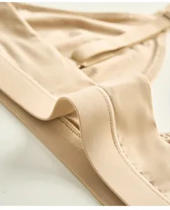 Close-up detail of women's seamless nude triangle bralette, soft fabric, comfortable.
