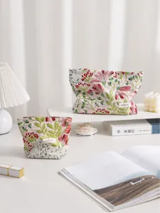Floral embroidered fabric cosmetic bag, stylish zip storage pouch for travel and daily use.