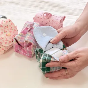 Cute quilted storage pouch detail, pastel plaid fabric with flap design and cherry print.
