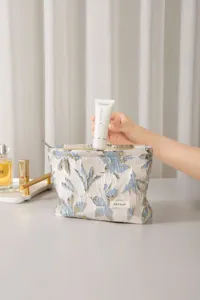 Detail view of the elegant jacquard cosmetic bag showing zipper closure and texture.