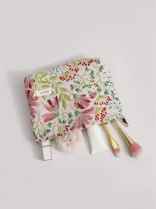 Floral embroidered cosmetic bag with zipper, portable fabric makeup pouch for travel and daily storage.