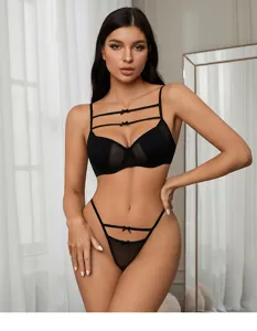 Sexy black mesh lingerie set for women, featuring strappy push-up bra and matching thong.