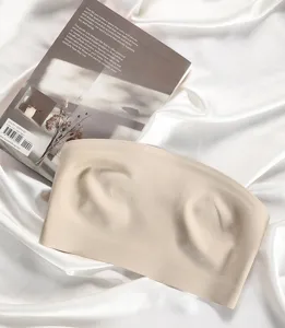 Beige strapless bandeau bra detail view, seamless lightweight underwear for women comfort.