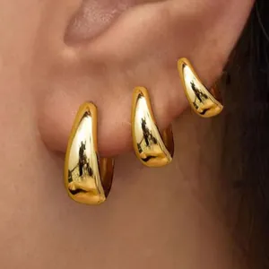 Klobige goldene tropfen ohrringe für damen, minimalistischer dicker reifenschmuck details.