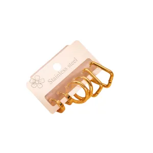 Stainless steel hoop earring set detail showing minimalist gold geometric shapes and fine finish.