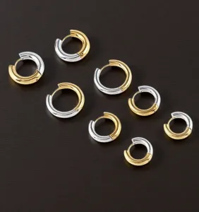 Stainless steel two-tone hoop earrings detail, gold and silver color blocked jewelry.