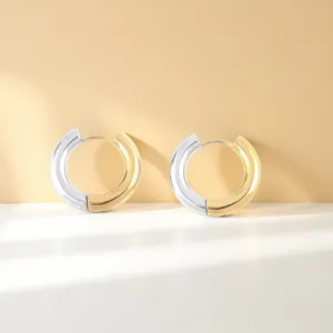Stainless steel two-tone hoop earrings detailed view showing gold and silver textured design.