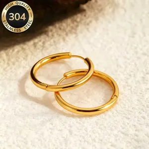 Gold stainless steel smooth hoop earrings detail, minimalist round circle design, fashion jewelry.