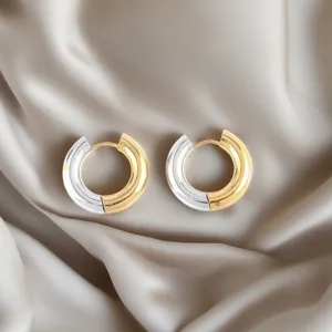 Detailed view of two-tone stainless steel hoop earrings with gold and silver finish.