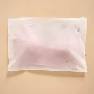 Detailed close-up of the pink seamless bra inside a frosted ziplock packaging bag.