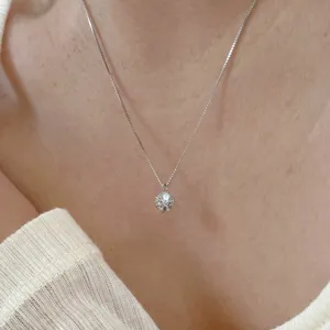 Close up view of the silver cubic zirconia pendant necklace showing sparkling faceted stone.
