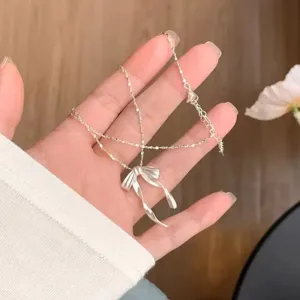Elegant silver bow necklace with layered chain design, minimalist fashion clavicle chain jewelry.