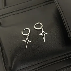 Silver hollow four-pointed star hoop earrings, cool sweet celestial jewelry detail shot.