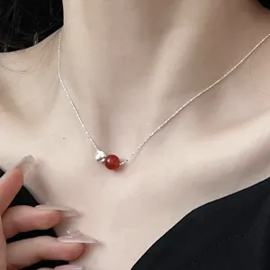 Close-up detail view of the sterling silver red agate clavicle chain necklace jewelry.