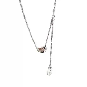 Minimalist s925 silver bean pendant necklace with lucky tag for women daily wear.