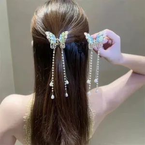 Exquisite butterfly hair claw detail with pearl tassel, elegant half-up hair accessory.