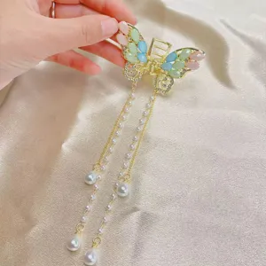 Elegant butterfly tassel hair claw clip for women, delicate half-up hair accessory.