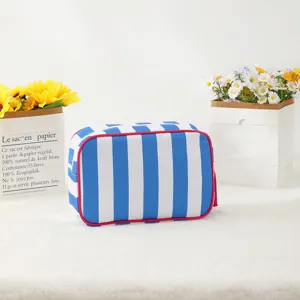 Striped waterproof cosmetic bag with red trim, portable travel toiletry storage bag for women.