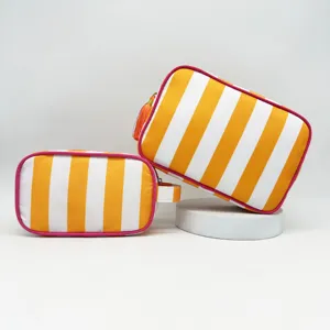 Detail view of the stylish striped cosmetic bag with tassel and durable zipper closure.