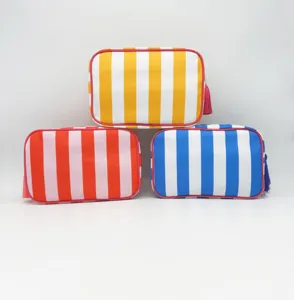 Detail view of colorful striped cosmetic bag, featuring waterproof fabric and stylish tassel.