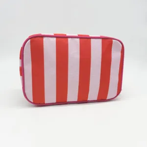 Detailed view of the red striped waterproof travel cosmetic bag, large capacity portable storage.