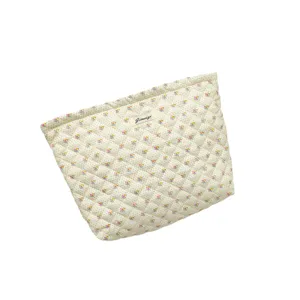 Quilted cosmetic bag with cute floral and dot pattern, portable makeup storage pouch.