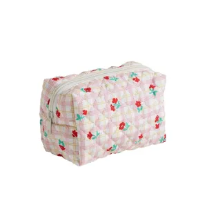 Quilted cosmetic bag with pink plaid and floral print, portable travel toiletry pouch.