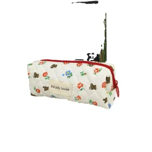 Quilted cosmetic bag with cute bear and floral pattern, portable travel makeup pouch.