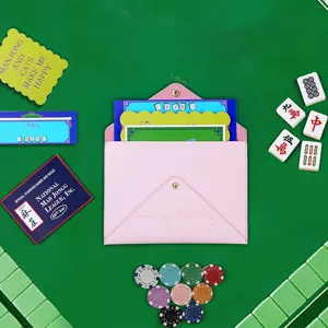 Detailed view of pink PU leather mahjong storage bag with accessories and themed cards.