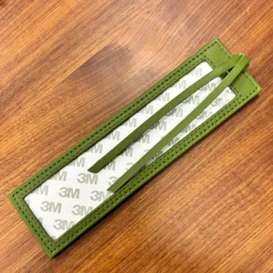 Green PU leather cross stitch bookmark sleeve with clear window and self adhesive back.