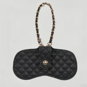 Detailed view of black quilted leather glasses case featuring a luxury gold chain.