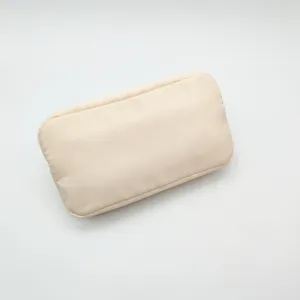 Compact beige nylon cosmetic bag detail view, ideal for travel storage and daily organization.