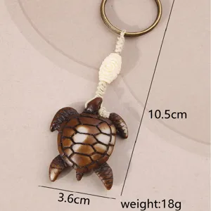 Detailed close-up view of the ethnic style turtle keychain with size and weight specs.