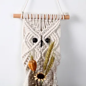 Handmade macrame owl wall hanging detail featuring intricate cotton cord weaving and bead eyes.