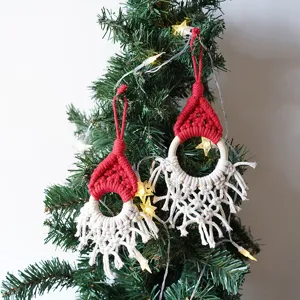 Closeup view of handmade macrame Christmas tree ornament with cute Santa hat design.