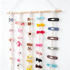 Cute macrame hair clip holder wall hanging organizer with colorful bows and clips for girls room decor.