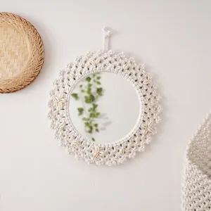 Handmade macrame wall hanging mirror with natural seashells, boho decorative round mirror detail.